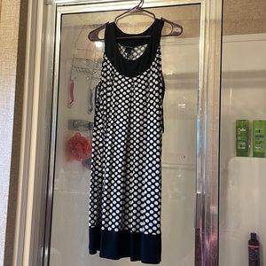 Black and white polka dot sleeveless dress. Hits at the knee or right above.